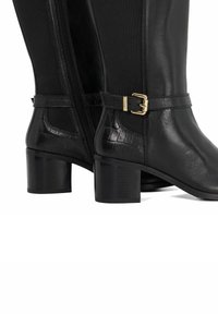 Black leather knee-high boots with a smooth finish, featuring a textured crocodile leather accent and a gold buckle detail near the ankle.