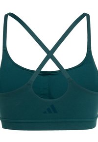 Sostenedor deportivo en color azul verdoso con tirantes entrecruzados, diseño de espalda redonda y costuras cosidas. Presenta un logotipo oscuro en el lado izquierdo. Textura de tela suave.