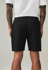 Next REGULAR FIT - Tepláky - black