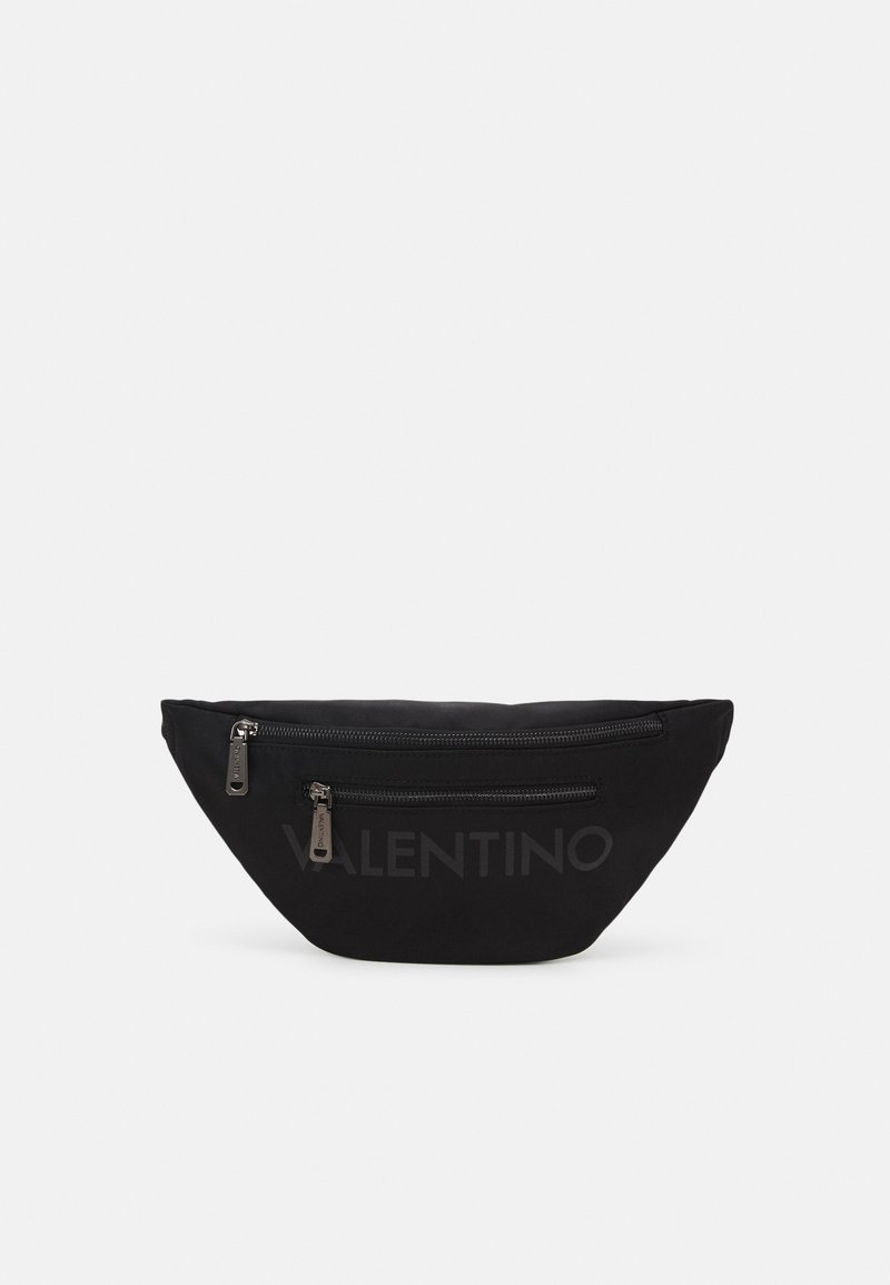 Black nylon fanny pack with two front zippers and embossed brand name on the front. Curved shape and smooth texture.