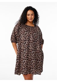 Leopard print dress with a relaxed fit, short puff sleeves, square neckline, and side pockets. Fabric has a smooth texture and vibrant colors.