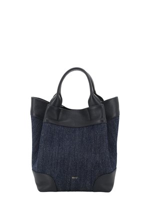 A navy blue denim tote bag with black leather handles, trim, and corner reinforcements, featuring a small gold logo on the front.