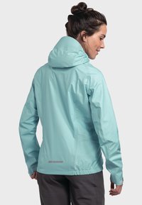 Lightweight, turquoise hooded jacket with elastic waist, seamless design, and reflective accents. Polyester material with smooth texture.