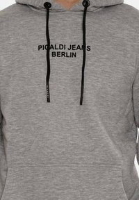 Gray hoodie with drawstrings, featuring a front pocket and black printed text "PICALDI JEANS BERLIN" across the chest. Soft texture.