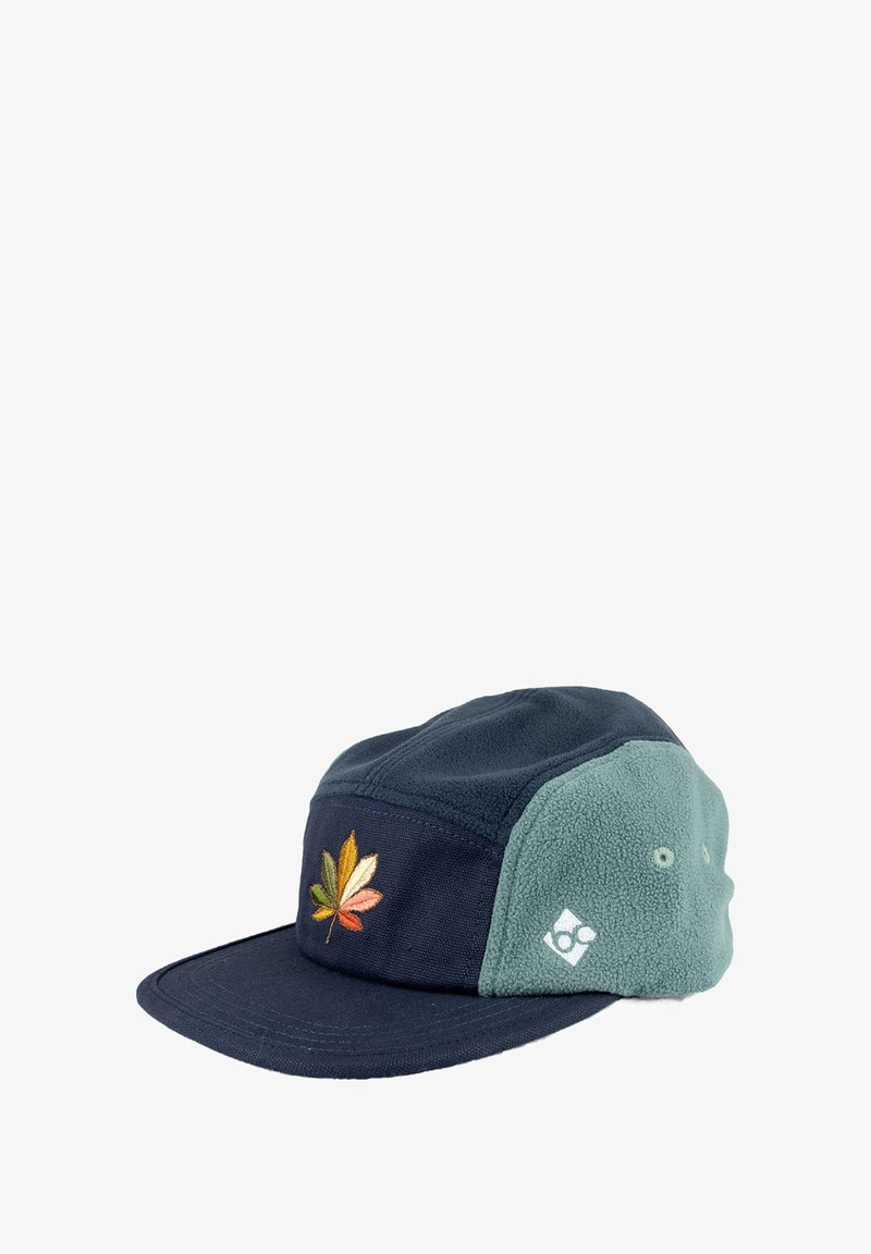 Marineblaue und grüne Kappe mit einem strukturierten Fleece-Panel und einem bestickten mehrfarbigen Blatt auf der Vorderseite. Der Schirm ist flach.