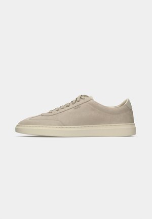 Beige suede lace-up sneaker with cream rubber sole and subtle stitching details, side embossed logo, and padded collar for comfort.