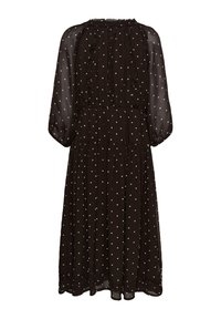 Robe midi noire à pois blancs, manches longues transparentes, détails à volants sur le corsage et taille froncée.