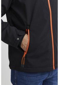 Black jacket with orange zipper and pull cord, featuring a zippered pocket at the side. Material appears smooth and durable.