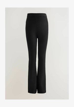 Black ribbed knit pants with a flared bottom and elastic waistband, featuring a textured fabric for flexibility and comfort.