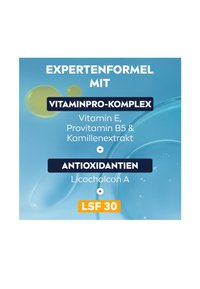 Skin care product label featuring a blue background, highlighted text for "Vitamin Pro Complex" and "Antioxidants," with "SPF 30" in orange.