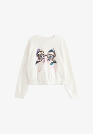 Witte sweater met lange mouwen, elastische zoom en een grote glanzende holografische strik op de voorkant.
