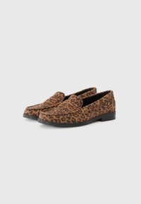 Leopard print loafers made of suede, featuring a rounded toe, flat black sole, and decorative stitching on the upper.