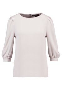 Blusa beige chiaro, con texture, scollatura rotonda, maniche a tre quarti a palloncino e una chiusura a cerniera discreta sul retro.