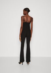 Calvin Klein CRINKLED FLARED - Pantaloni - black