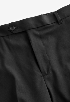 Melnas bikses ar tīru dizainu, plakanu priekšpusi, pogu aizdari un smalkām šuvju detaļām. Gluda, teksturēta auduma.