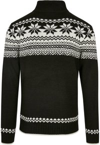 Suéter negro de punto con un patrón de copos de nieve blancos en la parte superior y acentos decorativos blancos en los puños y el dobladillo.