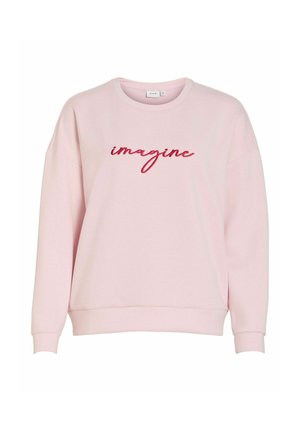 Lyserosa genser med rund hals, senkede skulder og ribbestrikkede mansjetter. Har rød brodert tekst "imagine" på forsiden.