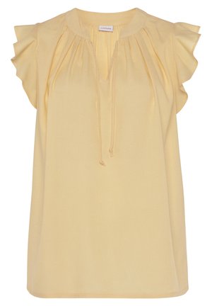 Blouse jaune à coupe décontractée, col rond et manches courtes à volants. Détails plissés allant du col jusqu'à l'avant. Tissu léger.