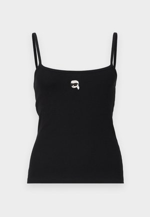 Must mustriba tank top õhukeste rihmadega, mille esiküljel on väike valge graafika tegelasest, kellel on prillid.