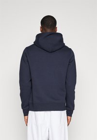 Tommy Hilfiger ARCHED VARSITY HOODY - Felpa - desert sky