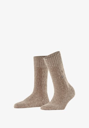 Chaussettes beiges à motifs avec un bord côtelé, de longueur mi-mollet et texture lisse, présentant un petit logo sur le côté.