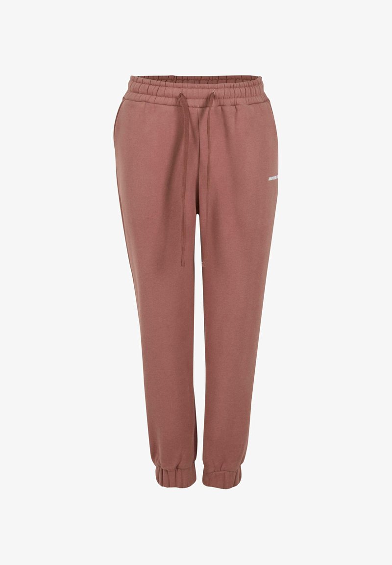 Pantalones de chándal color rosa hechos de una tela suave, con una cinturilla elástica y cordón ajustable, y puños elásticos en los tobillos.
