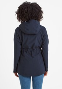 Navy blue jacket with a hood, adjustable waist drawstring, and buttoned cuffs. Smooth, water-resistant fabric with a simple design.