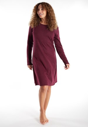 Long-sleeve dress in burgundy with a subtle animal print pattern, featuring a round neckline and relaxed fit that falls above the knees.