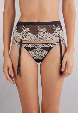 Black lace garter belt with cream floral embroidery, paired with matching mesh thong. Features adjustable black satin straps and floral accents.