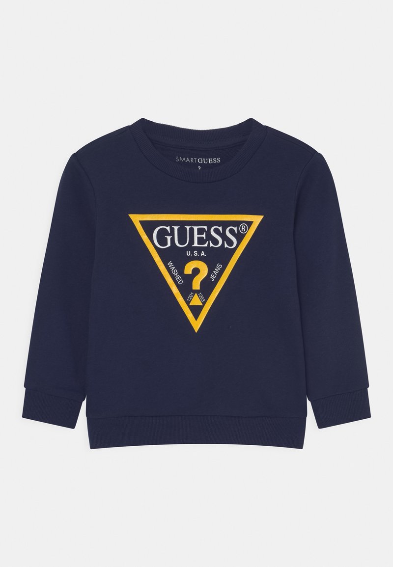 Felpa blu navy con maniche lunghe, caratterizzata da un logo a triangolo giallo con il testo "GUESS® U.S.A." e un design a punto interrogativo. Materiale misto cotone.