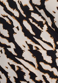 Black and ivory fabric with a tiger stripe pattern, featuring gold accents. The texture appears smooth with a slight sheen.