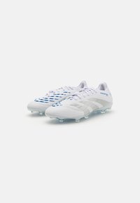 White soccer cleats with a sleek design, featuring textured upper, light blue accents, and translucent studs for traction.