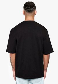 Black short-sleeve t-shirt featuring a relaxed fit and crew neck. Made of cotton with a smooth texture. No visible patterns or graphics.