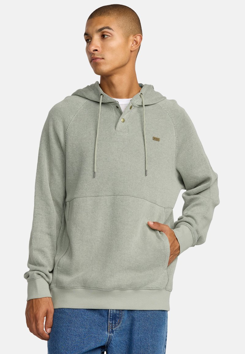 Lichtgroene hoodie met een gestructureerd ribbelontwerp, knoopsluiting bij de kraag en een voorzak. Voorzien van trekkoordjes en aansluitende manchetten.
