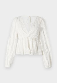 Hvit bluse med dyp V-hals, lange putete ermer, elastisk midje og blomsterbroderidetaljer. Har en knytelukking bak.