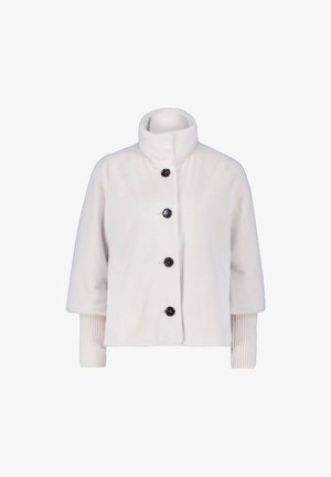 Light cream, short-sleeve jacket in soft, plush fabric with a high collar and five black buttons. Ribbed knit accents at the cuffs.