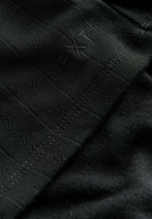 Black fabric featuring a textured ribbed pattern, with a smooth, soft area and subtle "Next" branding.