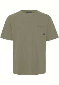 Olive green t-shirt made of cotton, featuring a crew neckline, short sleeves, and a chest pocket. Simple, unembellished design.