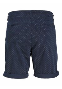 Pantalones cortos de color navy con un patrón de lunares, dobladillo vuelto y dos bolsillos traseros. Hechos de una tela suave y ligera, adecuada para el clima cálido.