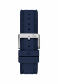 Söe sinine silikoonist kellarihm, millel on tekstureeritud pind, ristkülikukujuline hõbedane metallist pandla ja mitmed reguleerimishulgad suuruse seadmiseks. Graveeritud logo detail.