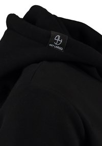 Felpa nera con una texture di tessuto morbido, caratterizzata da un'etichetta logo visibile sul colletto. Il design include una vestibilità ampia e un cappuccio regolabile.