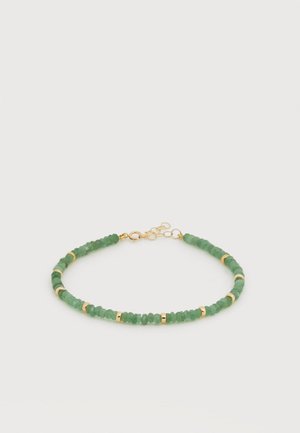 Karkötő kis zöld gyöngyökkel és egyenletesen elhelyezett arany gyűrűkkel, arany homárkapoccsal és állítható lánccal rögzítve.