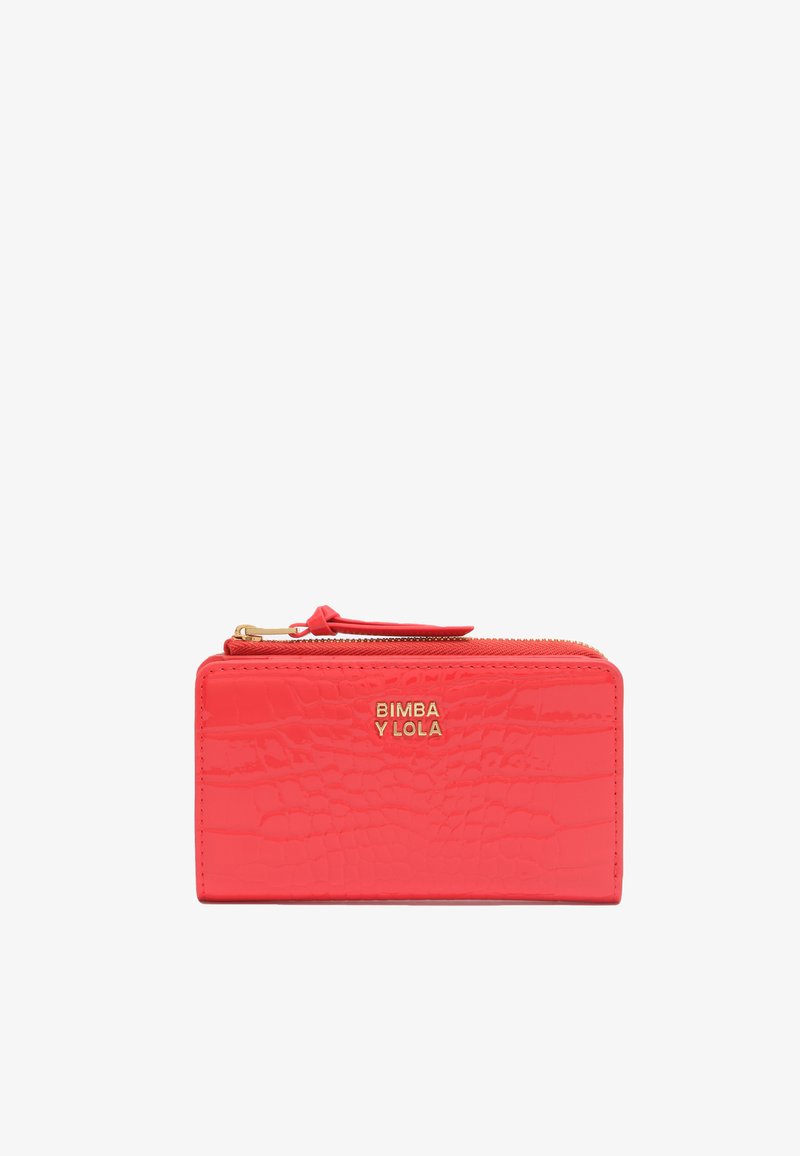 Coral pink faux crocodile leather wallet with gold logo, rectangular shape, zip closure, and textured surface for visual detail.