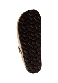 Semelle en caoutchouc marron avec un motif en vagues texturé, reliée à une tige beige avec une sangle. Forme arrondie, profil plat. Aucun logo ni motif visible.