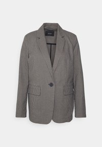 Veste à carreaux noir et blanc, avec un col à revers cranté, une fermeture à un bouton et deux poches avant. Tissu texturé avec une coupe ajustée.