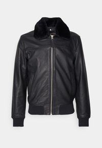 Svart läderjacka med pälskrage, silvrig dragkedja, ribbade manschetter och sidofickor. Slät textur med en figurnära design och inga synliga mönster.