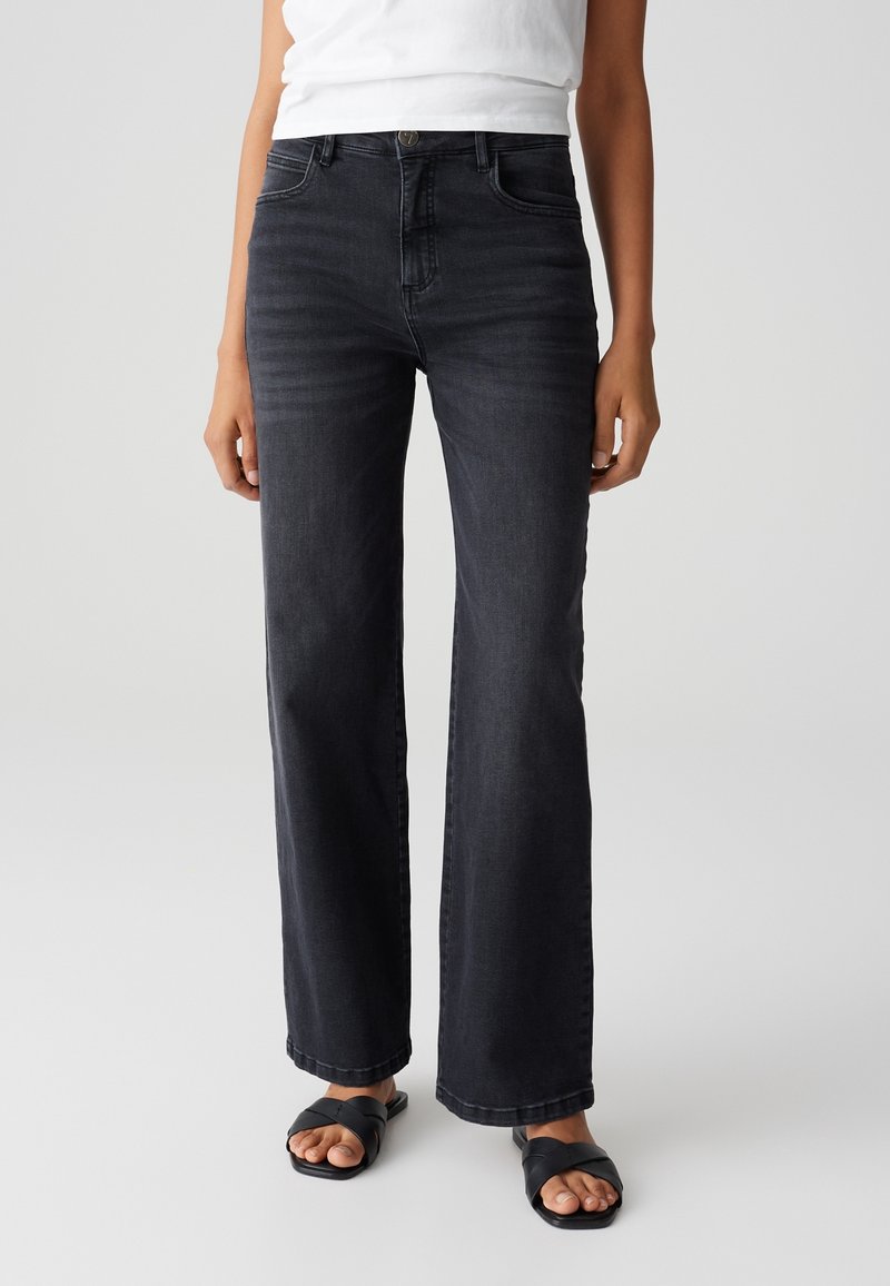 Dark wash, wide-leg jeans with a mid-rise waist, five-pocket design, and subtle fading. Made of denim fabric with a smooth texture.