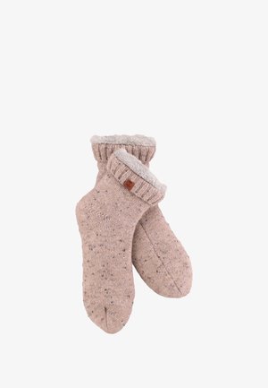 Stricksocken in sanftem Beige mit einem strukturierten Muster und einem hellgrauen Plüschfutter. Mit einem umgeschlagenen Bündchen und einem kleinen Lederelement.