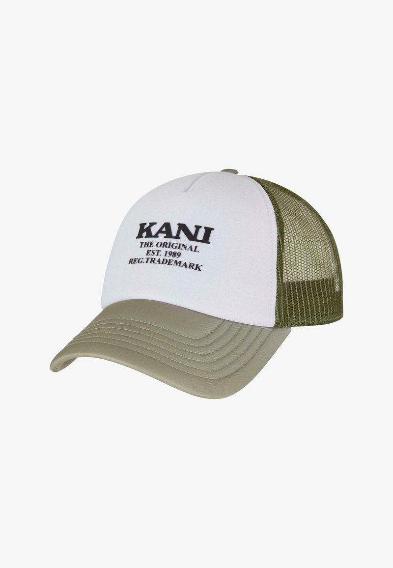 Balts beisbola cepures ar khaki vizieri un acs aizmuguri. Ar melniem izšūtajiem burtiem: "KANI THE ORIGINAL EST. 1989 REG. TRADEMARK."