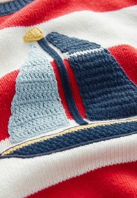 Knit sweater featuring a blue and white boat motif on a striped red and white background, with textured detailing and a yellow accent.